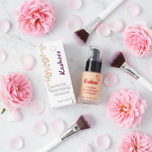 Kashees Foundation flat lay with pink roses and makeup brushes on marble