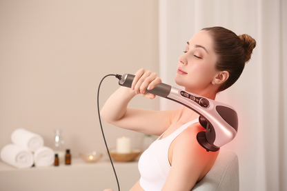 Woman using handheld infrared massager on neck and shoulder